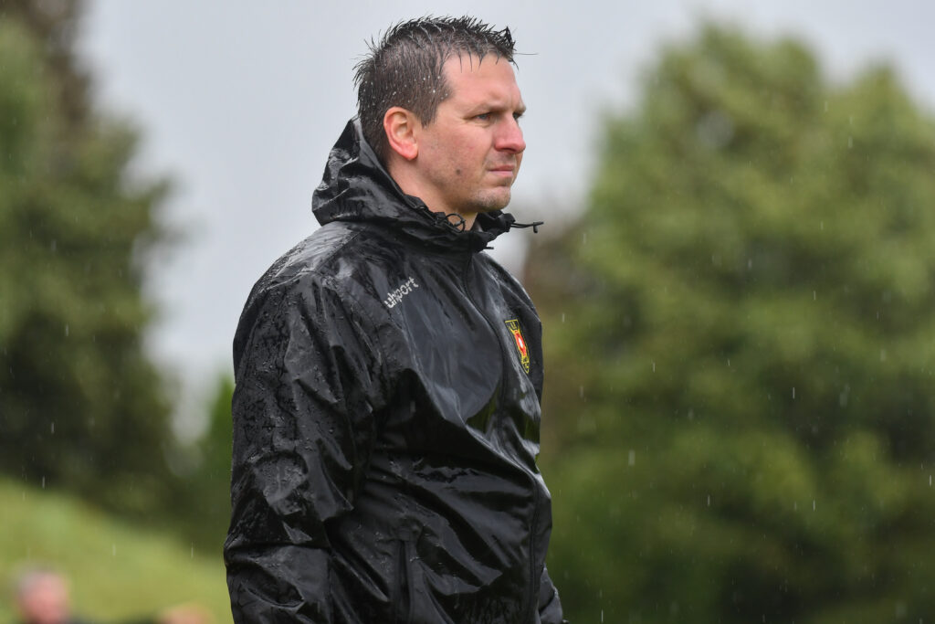 Albion Rovers Manager Steven Saunders drenched due to inclement weather.