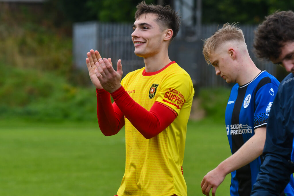 Albion Rovers' Alex McCaw applauding fans at full-time.